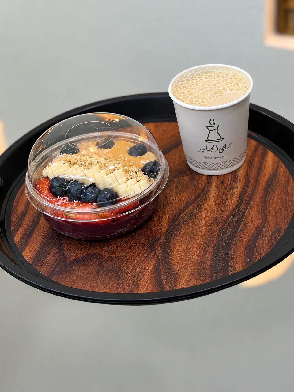 Acai bowl with fruit alongside a Shai Al Gabbani karak cup